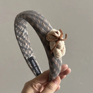 Chic plaid padded headband featuring a cute beige teddy bear and leather bow accent