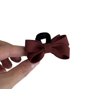 French style red twill hair claw clip with golden heart label and textured fabric