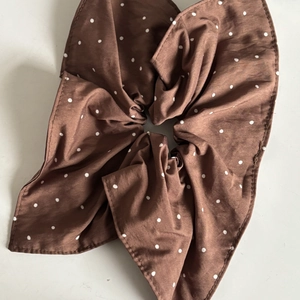 Deep chocolate brown polka dot bow scrunchie accessory for women on white background
