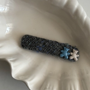 Cute blue fabric hair clip with 3D resin bears displayed on a white shell tray
