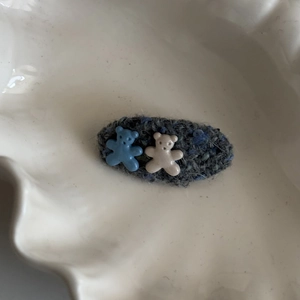 Detail of tweed BB hair clip with two cute 3D resin bears in blue and beige