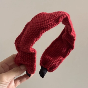 Red knitted wide headband for women featuring a textured pleated design and high top style