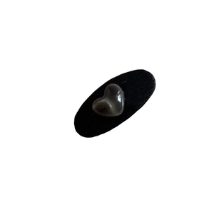 Elegant leather bow hair clip with a sleek heart-shaped pearl in a minimalist black design