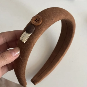 Brown padded velvet headband with decorative button and handmade label for women