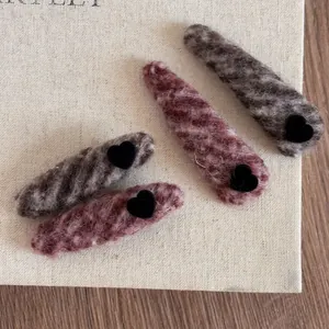 Close-up of leopard print velvet heart hair clips with soft faux fur texture details