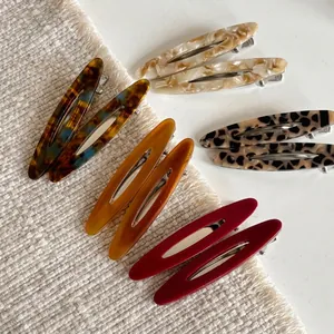 French oval hollow acetate hair clips in marble, tortoise, and amber patterns