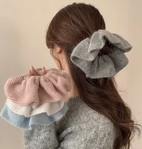 Detailed view of oversized knit mohair hair scrunchies in four soft pastel colors
