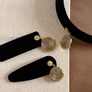 Detailed macro shot of vintage gold spiral pendants with intricate ethnic filigree craft