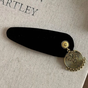 Vintage black velvet hair clip with ethnic gold tassel pendants and detailed engraving