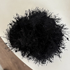 Elegant black fringe scrunchie with soft fluffy texture for women's hairstyle
