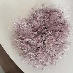 Fuzzy lavender scrunchie with tassel fringe texture for a sweet aesthetic hairstyle