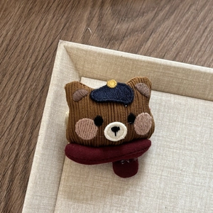 Cute brown corduroy bear hair clip for kids with blue beret hat on beige tray