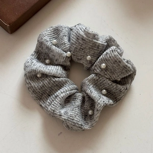 Grey knitted scrunchie with white pearls for women's low ponytail hairstyle