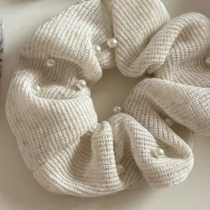 White mesh knit scrunchie with delicate faux pearls for elegant low ponytail styling