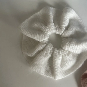 Close-up detail of white knitted scrunchie showing premium ribbed texture and soft fabric