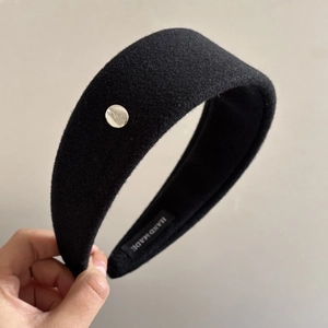 Detail of handmade wool headband with silver metallic buckle and believe in yourself engraving