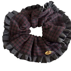 Vintage red and black plaid scrunchie with ruffled edges and golden metal logo charm