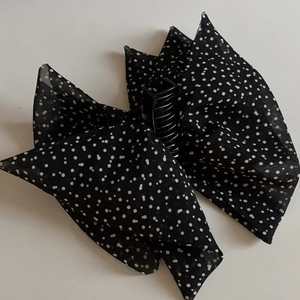Dettaglio della molletta per capelli vintage francese con fiocco a pois in chiffon nero
