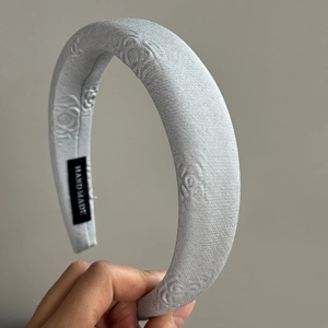 Light grey padded floral embossed fabric headband with handmade label detail