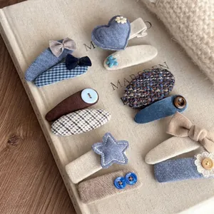 10-piece handmade blue and beige fabric hair clips set with heart and bow details