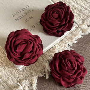 Elegant deep red fabric rose hair claws in a vintage floral style with textured petals