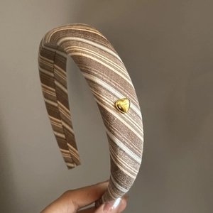 Retro padded headband with colorful striped fabric and gold heart charm detail