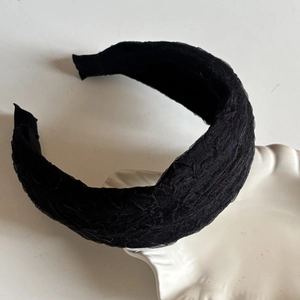 Elegant black thick headband with lace texture for a high-top vintage hair look