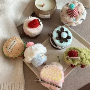 Detail of plush dessert hair clips including strawberry cake and burger shapes