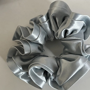Elegant silver satin scrunchie with pleated texture and pearl luster finish for women
