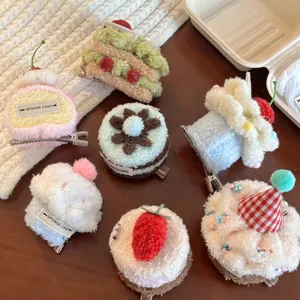 Macro detail of plush dessert hair clips like sponge cakes on a rustic tea party setting