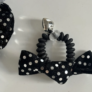 Black polka dot bow hair tie with silver heart pendant and spiral elastic cord