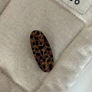 Macro shot of high-quality leopard print hair clip with smooth edges and oval shape