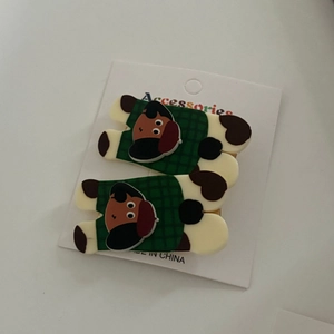 Detail of cute dog pattern hair clips with green plaid on acrylic base and metal grip
