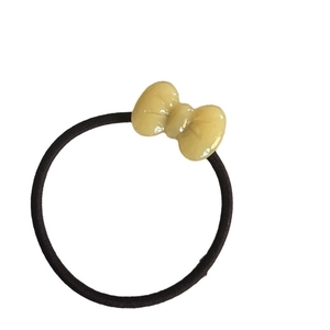 Elastic black hair tie with a 3D translucent yellow resin bow accessory for women