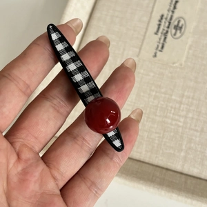 Elegant checkered hair clip featuring a large red pearl bead and French vintage style