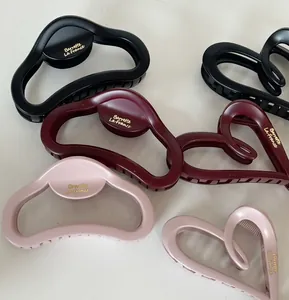 Detail of matte hair claws in black, burgundy and pink with La France golden text