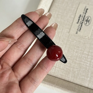 Classic black and white plaid hair clip with a vintage red pearl bead accent