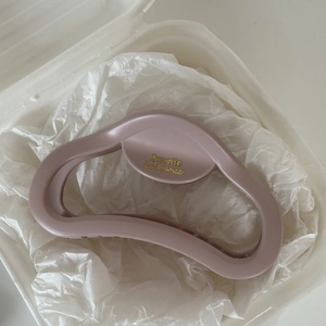 Matte pink French style large hair claw clip with golden text detail on white background
