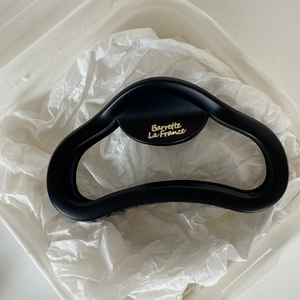 Detailed view of large black matte hair claw with golden Barrette La France text design