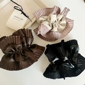 Three-piece set of leather and pleated chiffon scrunchies in pink, brown, and black colors