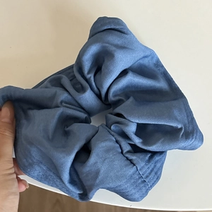 Denim blue oversized scrunchie hair tie made of soft textile with elegant ruffled folds