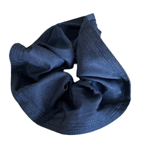 Deep blue denim scrunchie hair tie with contrast stitching on white background