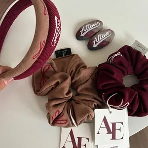 Velvet hair accessory set with burgundy and khaki headband, scrunchie, and clip