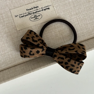 Elegant leopard print bow scrunchie for women with classic brown and black silk texture