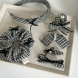 Detailed set of black and white plaid hair accessories with bows and faux pearls