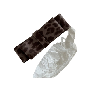 Brown leopard print bow hair clip with velvet fabric texture on a clean white background