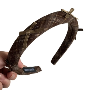Brown plaid academic style headband with three satin bows and a handmade fabric label