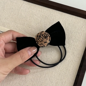 Vintage velvet bow hair tie with leopard print rose detail for elegant hair styling
