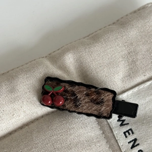 Cute cherry and leopard print plush duckbill hair clip with retro style on canvas
