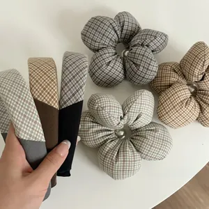 Detail of plaid fabric scrunchies and headbands with elegant pearl centers
